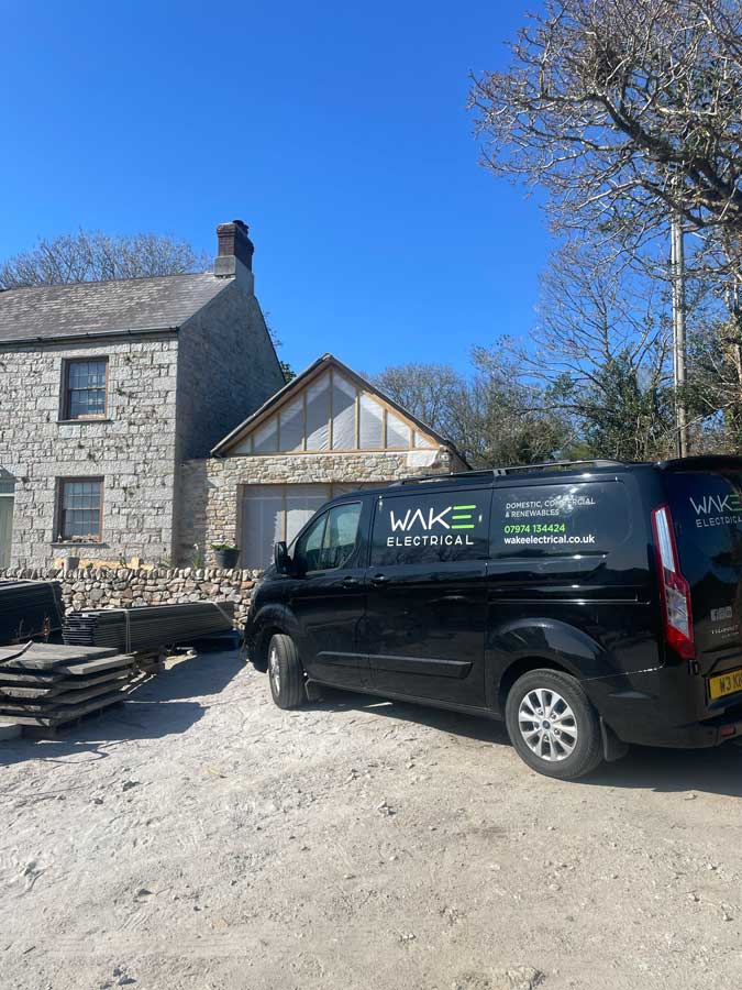 Branded Wake Electrical van on domestic electrician worksite.